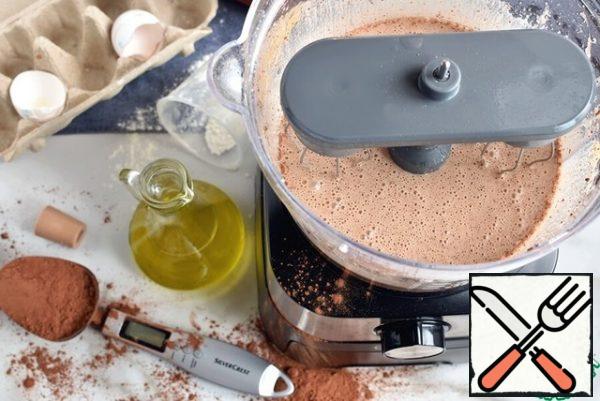 Without stopping whipping, pour vegetable oil in a thin stream through the hole in the lid. Beat for 1 minute.