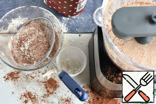 Separately, sift the mixture of flour, salt, cocoa powder, baking powder and soda into a bowl. Pour the mixture into the bowl of the combine and punch in pulse mode until it is roughly combined-a few seconds.