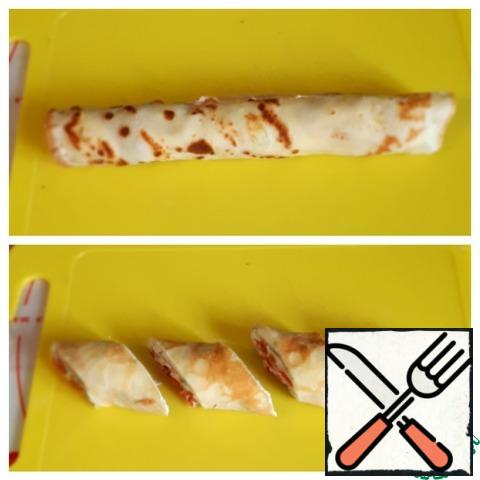 Turn the pancake into a roll and cut diagonally into small portions.