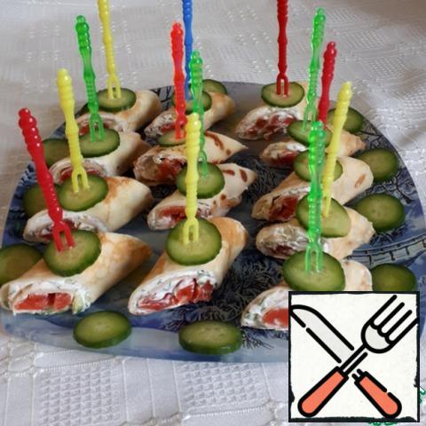 Decorate the rolls with a cucumber circle and pierce with a skewer, serve on a festive table on a beautiful plate.