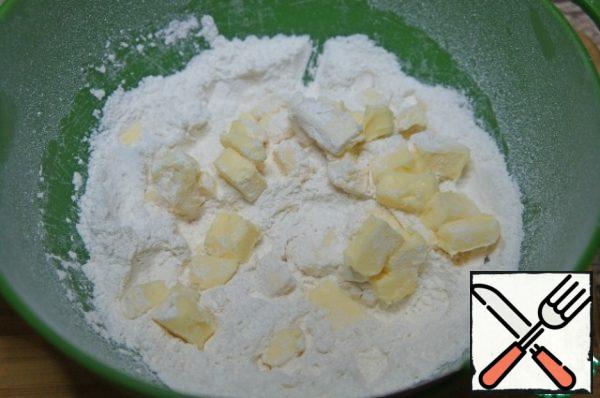 Mix flour, salt, and sugar. Add pieces of cold oil and RUB with your hands into a homogeneous crumb.