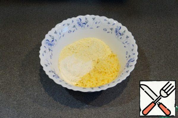 Mix finely grated cheese, corn and wheat flour.
