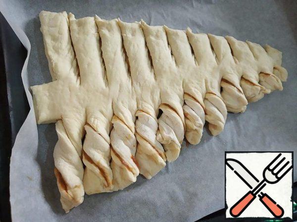 Each strip of dough is twisted, forming branches of the Christmas tree.