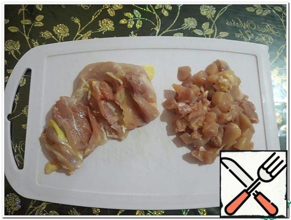 Chicken meat is separated from the bones and cut into small arbitrary pieces.