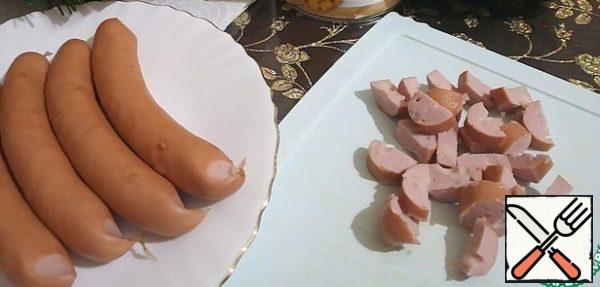 Cut into small pieces of sausage. They should be smoked. I have "Bavarian" with cheese.