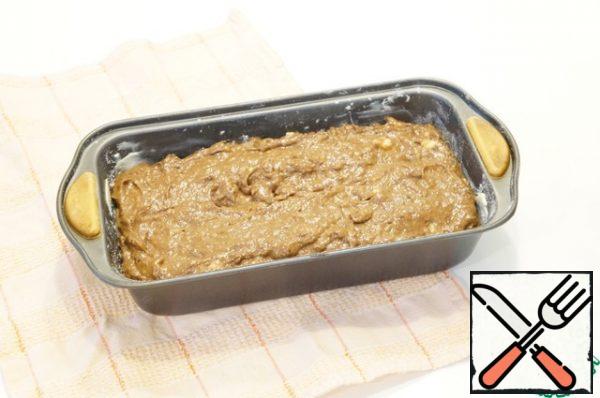 Put the dough in a greased and floured form and smooth it out slightly.
