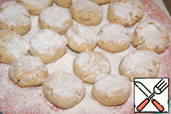The finished cookies are lined with a layer on the dish and just a little sprinkle with flower water, which is poured into a spray bottle (like a spray bottle for water). Top generously with powdered sugar. Do the same with the rest of the cookies.