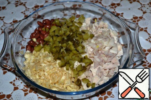 Add the pickled cucumbers, cut into small cubes, and finely chopped onion.