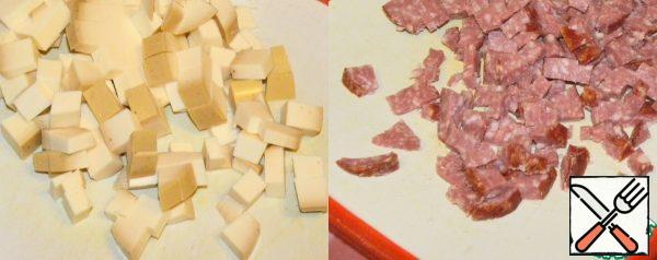Cut the cheese and sausage into cubes.