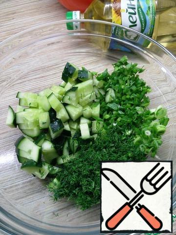 Chop the green onions and dill finely and put them in a bowl with the cucumbers.
