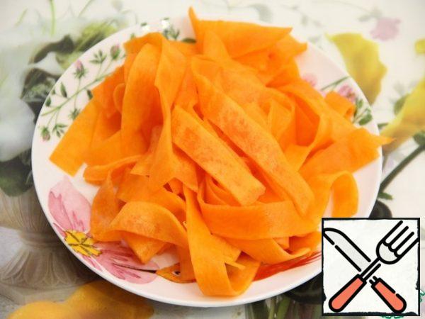 Cut the pumpkin into strips using a vegetable peeler.