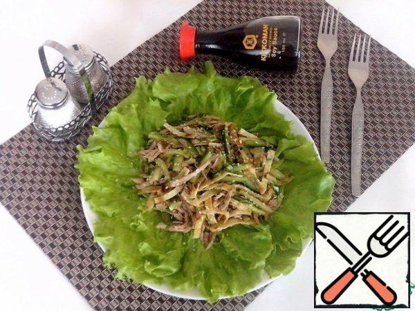 Put the washed and dried lettuce leaves on a plate, spread the salad on them, sprinkle with sesame seeds and serve immediately.