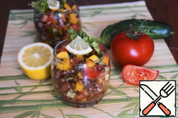 Put the finished salad into glasses. Garnish with herbs and a slice of lemon. Serve to the table.