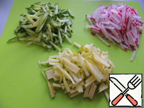 Radish, apple and cucumber cut into strips.
