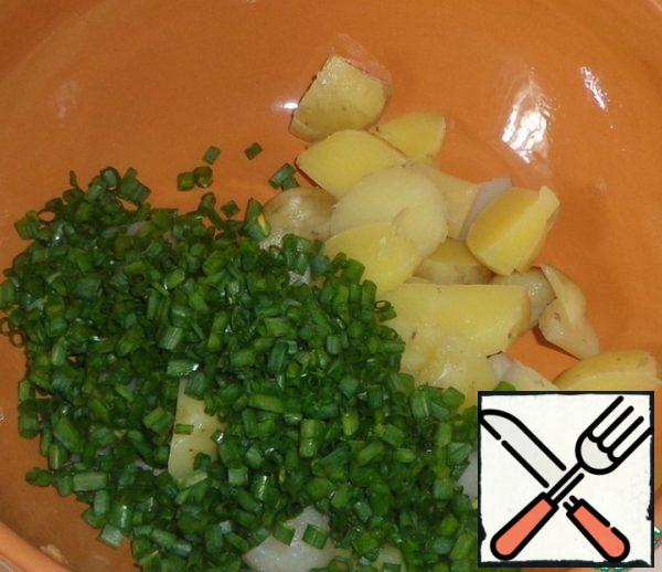 Add the chopped green onions to the potatoes.