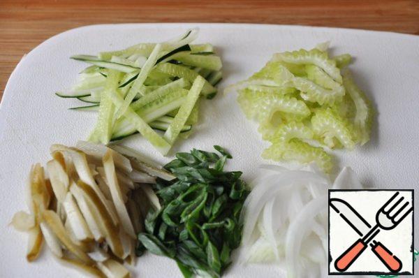 Onions cut with arrows; celery, cucumber fresh and marinated in thin strips, green onion rings.