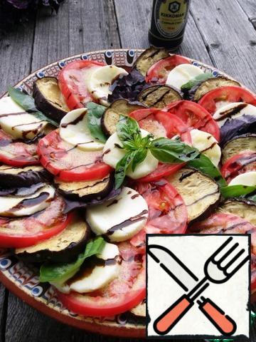 Place the eggplant, tomato, cheese, and Basil leaf on a platter, alternating, until the salad ingredients run out. Before serving, pour the dressing, and top with balsamic.
