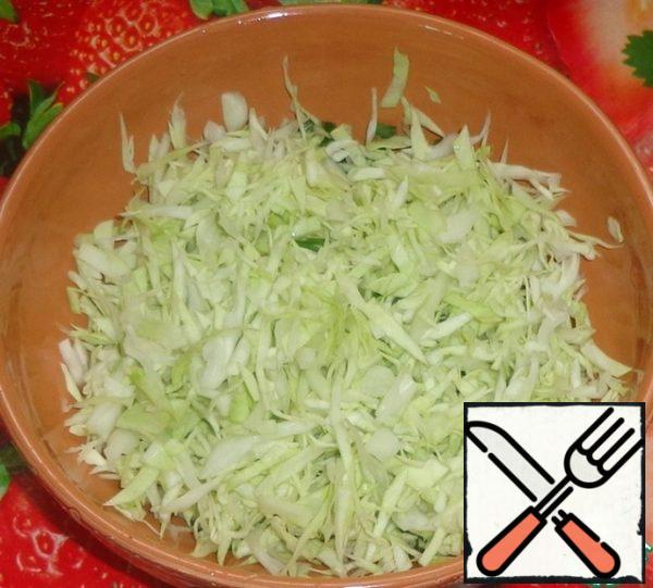 Mash the cabbage with your hands and add it to the onion.
