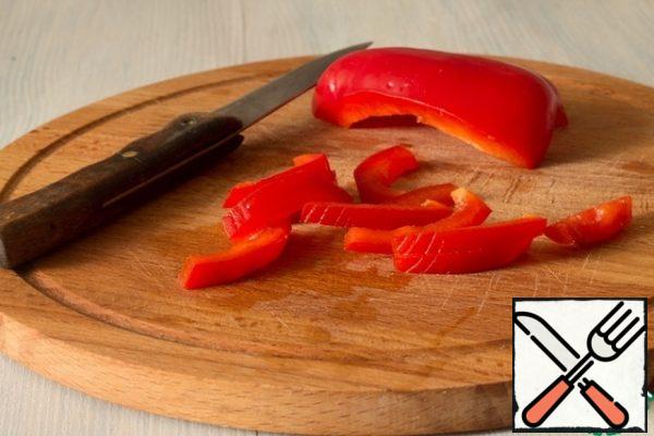 Peel the peppers and cut them into thin strips.