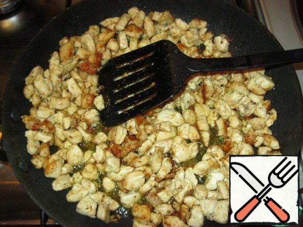 Cut the chicken fillet into small pieces and fry in a small amount of oil until Golden brown.