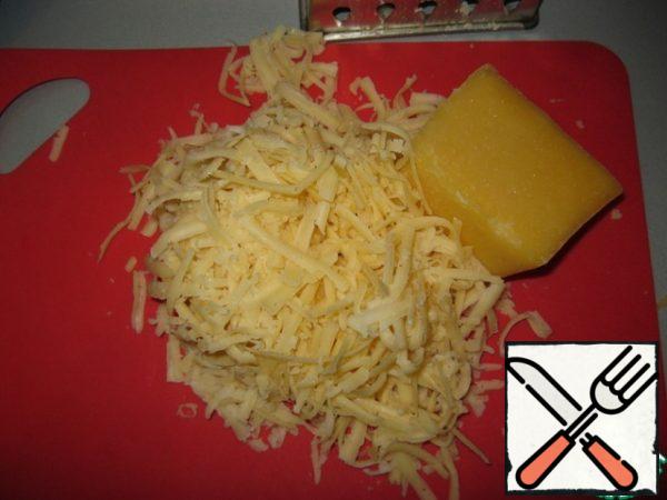 Grate the cheese on a large grater.