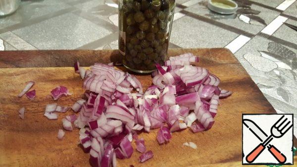 Cut the red onion and add the capers.