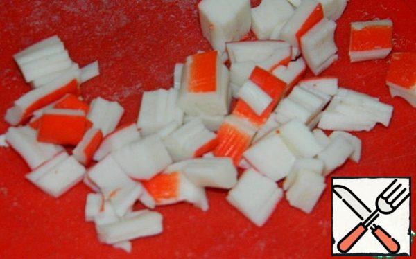 Slice the crab sticks.