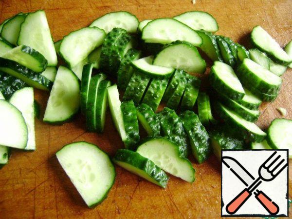 Cucumbers cut into half rings.
Add to the cabbage.
