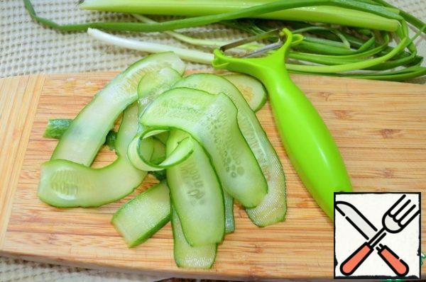 Cucumber cut into thin slices with a vegetable peeler.
Add a little salt, this will help in the further formation of rolls.