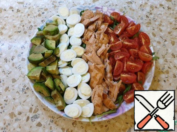 Then lay out the chopped eggs and avocado.