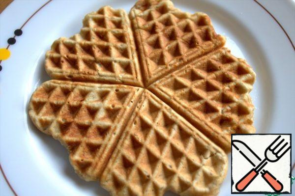 Transfer the finished waffles to a plate or grill. Continue baking the rest.