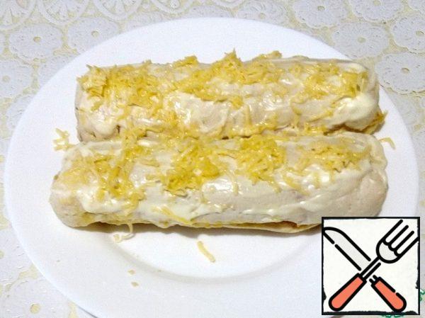 Then remove the rolls, remove the film, sprinkle with grated cheese and send it to the oven for another 5 minutes to melt the cheese.