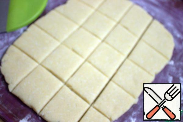 Separate half of the dough and roll out into a rectangle, divide into squares.