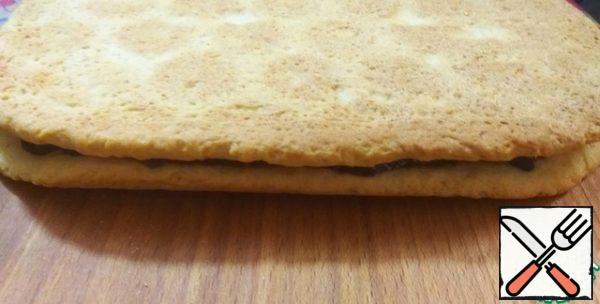 Cover with the second half of the cake.
Cool.
If desired, trim the uneven edges.
