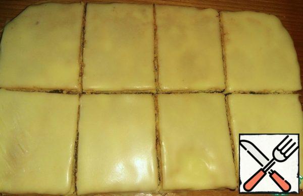 Cakes with jam and icing cut into portion cakes.