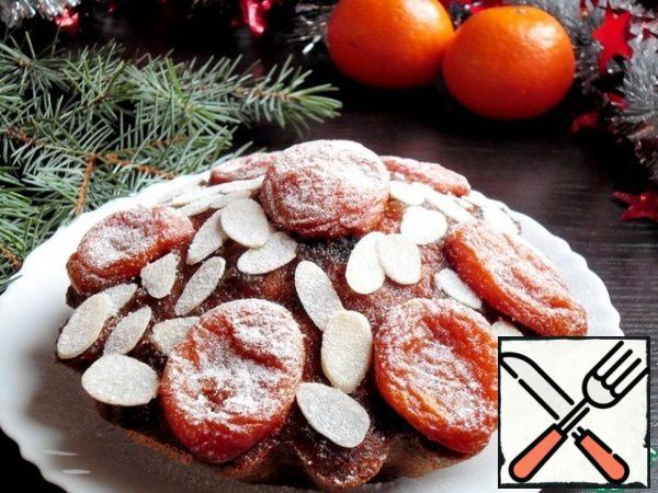 Sprinkle with almond petals or ground nuts, put slices of dried apricots, sprinkle with powdered sugar.