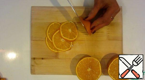Cut oranges into circles.