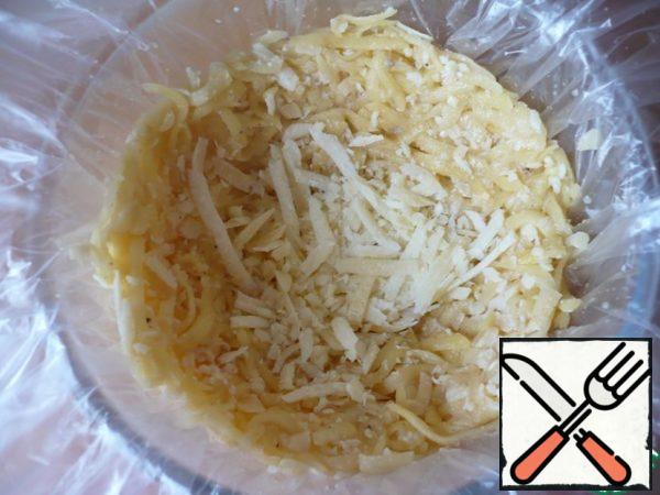 Sprinkle some of the remaining chopped Parmesan cheese over the potato mass.