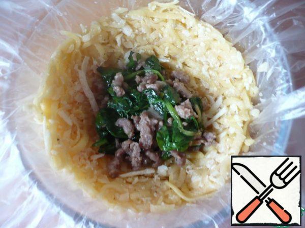 Then add a large spoonful of cooked meat filling.
