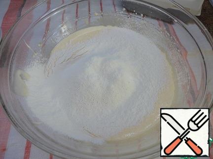 Beat the yolks with sugar into a fluffy light mass, add the milk, mix, then sift the flour mixed with baking powder into it and mix.