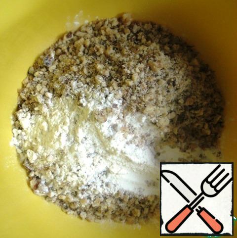 In a bowl, combine the flour, a pinch of salt, chopped nuts and baking powder. Stir.