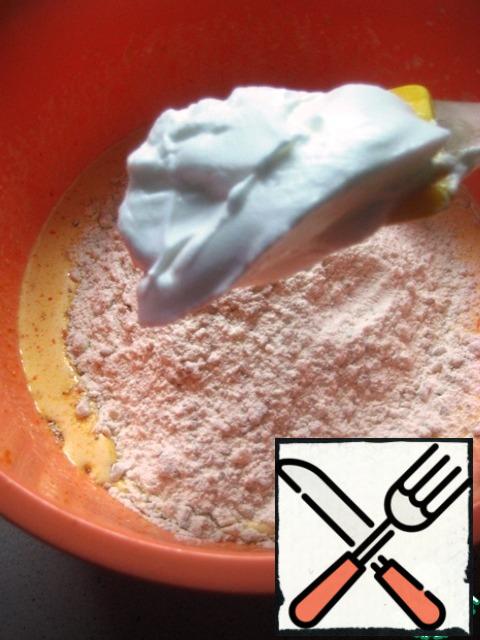 Pour in the nut-flour mixture and gradually add the whipped whites, gently mix the dough until smooth.