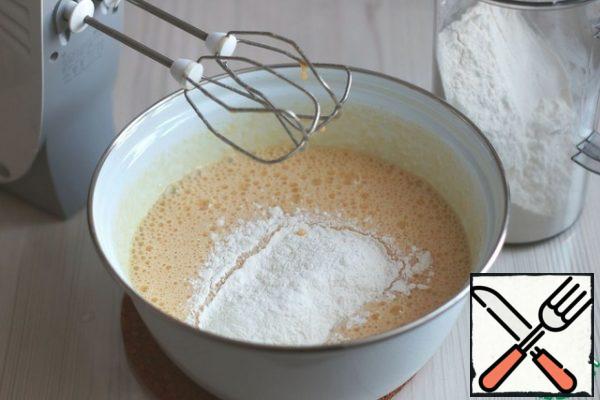 Then add gradually, in portions, the total amount of flour.