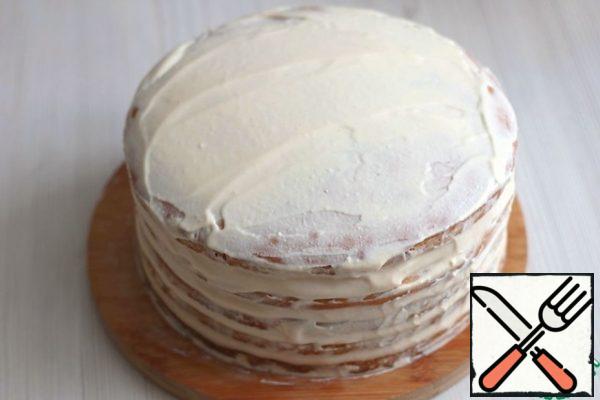 Spread the prepared cream on the cakes, the top and sides of the cake, then sprinkle with crushed crumbs. Decorate the cake to taste. As a decoration in this recipe, ready-made chocolate glaze was used.