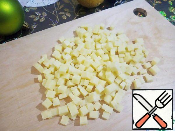 Cut the hard cheese into small cubes - 0.5 cm.