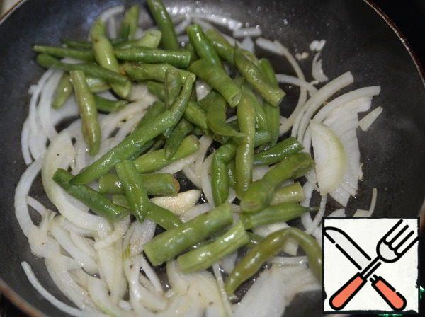 Put onion in a pan with duck fat, fry for 2 minutes until transparent, add green beans. Mix. Stew over medium heat for 5 minutes.