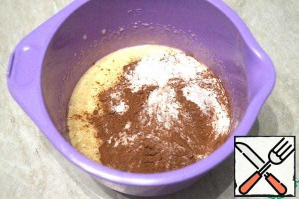 Add the sifted flour, cocoa, baking soda and baking powder.