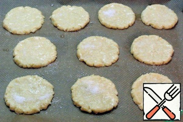 Brush the cookies with egg white and sprinkle with sugar.
