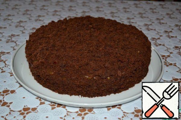 Sprinkle the top and sides of the cake with truffle biscuit crumbs, lightly pressing it with your hands to the base-sides and top.