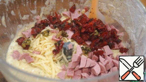 Add cheese, sausage, finely chopped tomatoes, a jar of olives in rings to the dough.